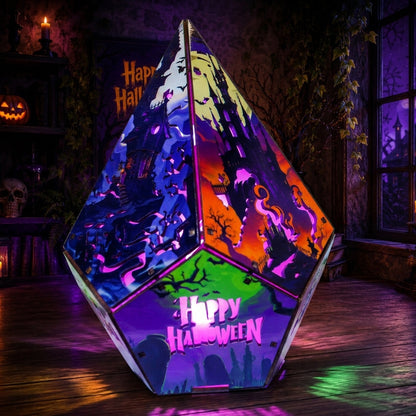 A large, faceted geometric LED light sculpture with a colorful Halloween-themed cutout design, featuring 'Happy Halloween' text and spooky silhouettes, set in a dark, atmospheric room.