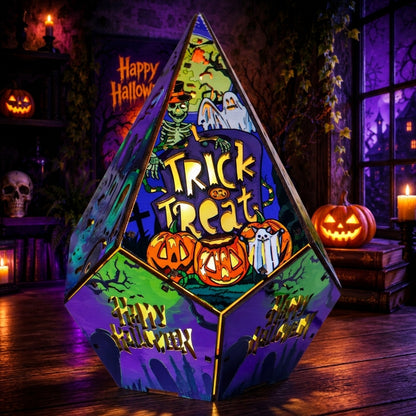 A large triangular pyramid-shaped Halloween decoration with colorful printed panels reading 'Trick or Treat' and 'Happy Halloween,' styled in a dark, spooky room with jack-o'-lanterns, candles, and a skull.